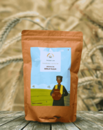 The Deep Soil Barley Flour Jau Ka Atta package on wooden table with sunlit barley field background