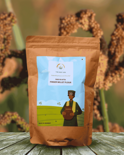 The Deep Soil Finger Millet Flour Ragi Ka Atta package on wooden table with brown ragi crop background