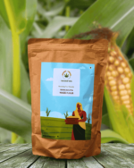 The Deep Soil Maize Flour Makke Ka Atta package on wooden table with ripe corn cob on plant background