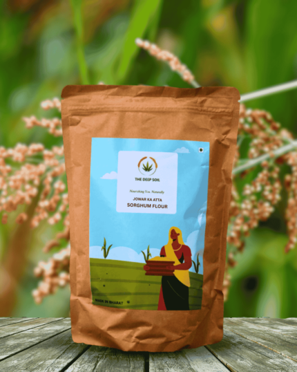 The Deep Soil Sorghum Flour Jowar Ka Atta package on wooden table with Sorghum crop field background