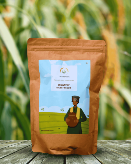 The Deep Soil Browntop Millet Flour package on wooden table with green millet stalks background