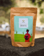 The Deep Soil Gharat Ka Ragi Ka Atta Finger Millet Flour brown paper package on a stone surface with nature background