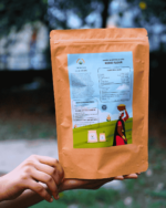Hands holding The Deep Soil Kodo Flour Kodra Atta package back view with nutritional facts