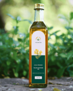 500ml bottle of The Deep Soil Cold-Pressed Yellow Mustard Oil on a stone surface with nature background