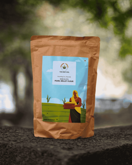 The Deep Soil Pearl Millet Flour Bajra Ka Atta brown paper package on a stone surface with nature background