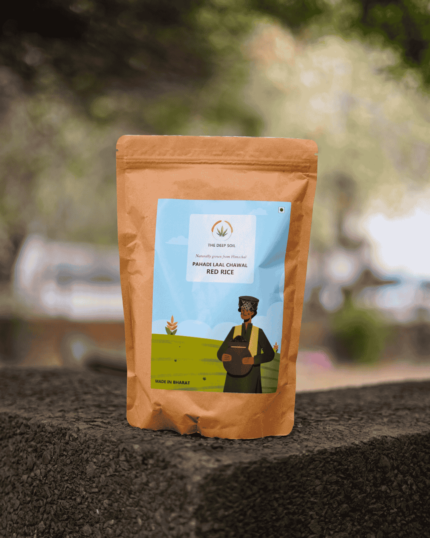 The Deep Soil Pahadi Laal Chawal Red Rice brown paper package on a stone surface with nature background