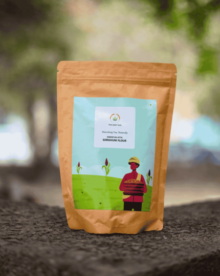 The Deep Soil Sorghum Flour Jowar Ka Atta brown paper package on a stone surface with nature background